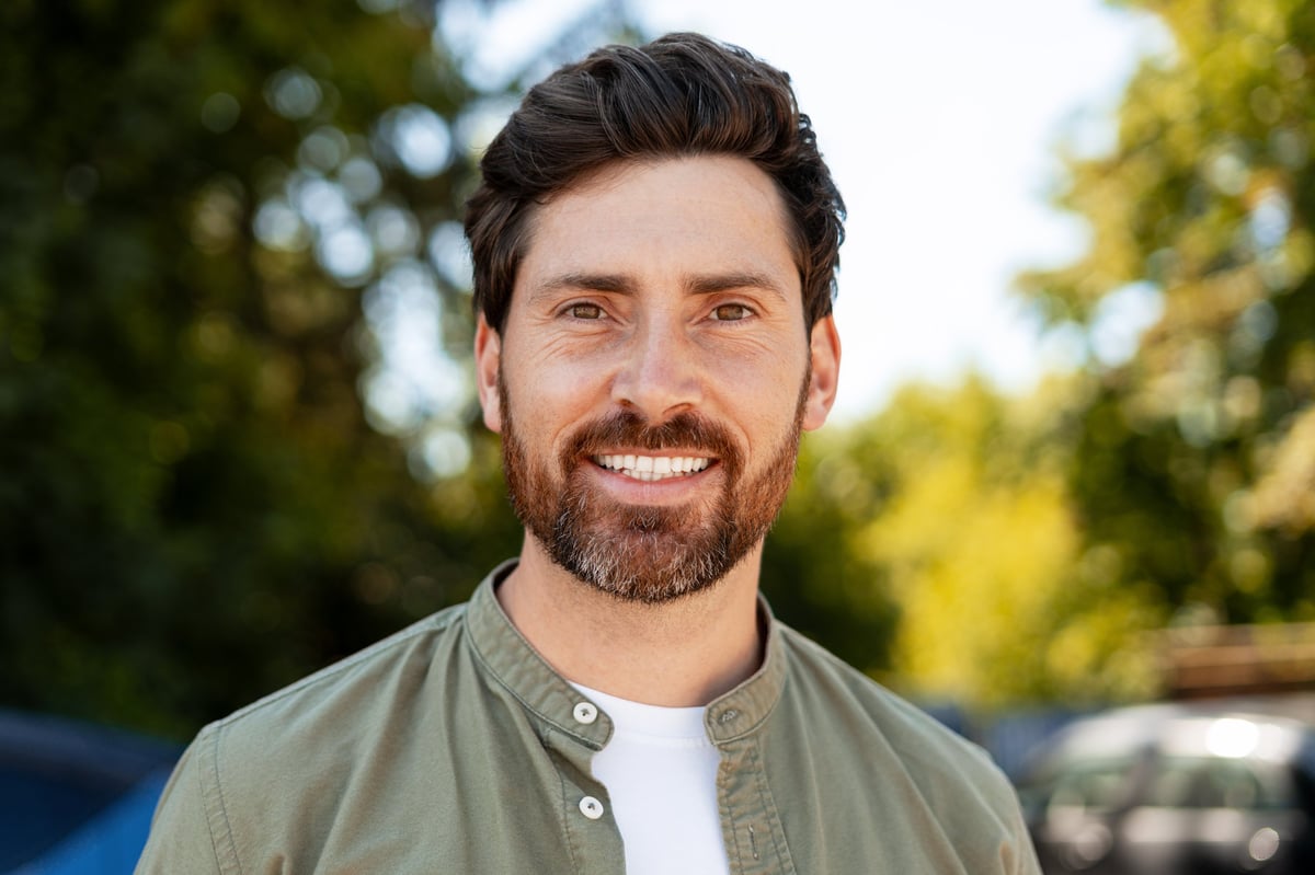 Cheerful mid adult man with a beard enjoying the outdoors