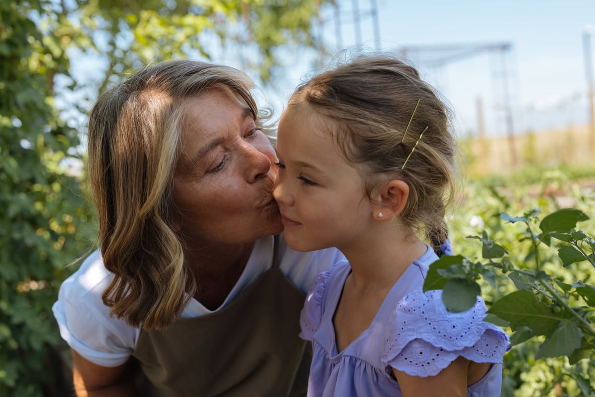 Grandmother sharing a tender moment with her granddaughter outdoors